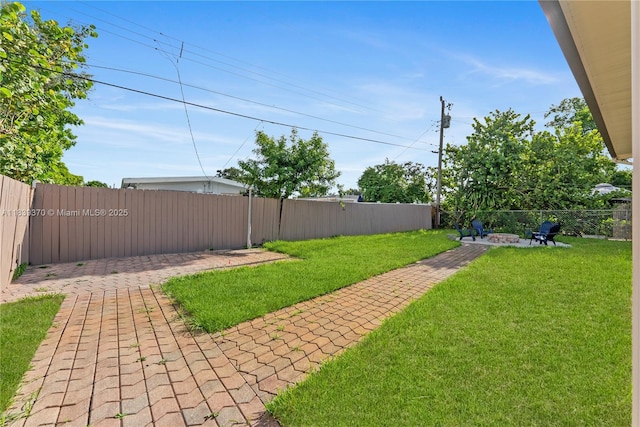 7021 SW 12th St, Pembroke Pines, FL 33023 - fenced backyard with an outdoor fire pit and a patio area