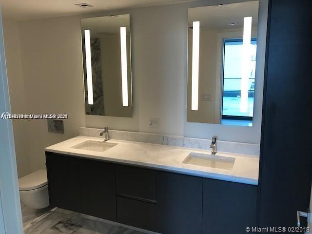 1451 Brickell Ave Unit 902, Miami, FL 33131 - full bath with marble look tile flooring and double vanity