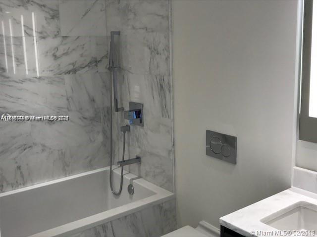 1451 Brickell Ave Unit 902, Miami, FL 33131 - bathroom with vanity and a combined bath / shower with marble appearance