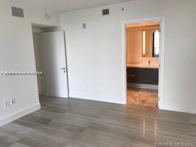 1451 Brickell Ave Unit 902, Miami, FL 33131 - spare room with baseboards and a sink