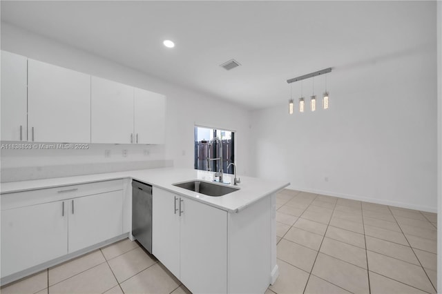 12960 SW 232nd Ln, Homestead, FL 33032 - kitchen featuring stainless steel dishwasher, a peninsula, white cabinetry, light countertops, and light tile patterned floors