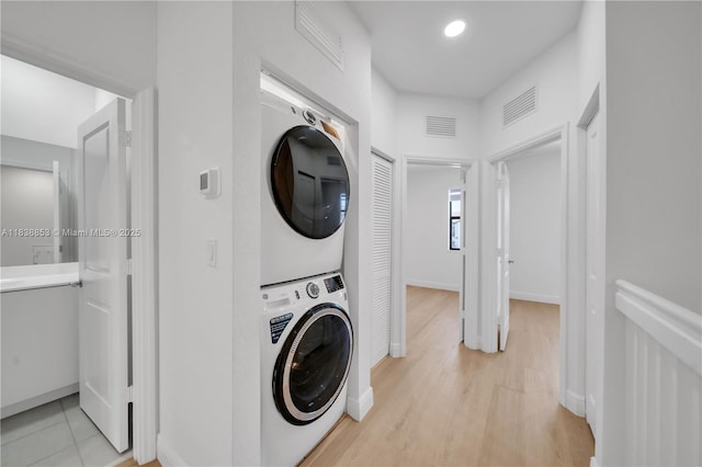 12960 SW 232nd Ln, Homestead, FL 33032 - washroom featuring stacked washer / dryer and light wood-type flooring