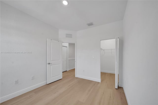 12960 SW 232nd Ln, Homestead, FL 33032 - unfurnished bedroom with light wood finished floors and a walk in closet