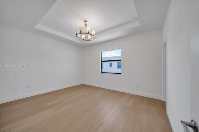 12960 SW 232nd Ln, Homestead, FL 33032 - spare room with a chandelier, light wood-type flooring, and a raised ceiling