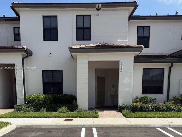 12960 SW 232nd Ln, Homestead, FL 33032 - view of front of home featuring stucco siding and uncovered parking