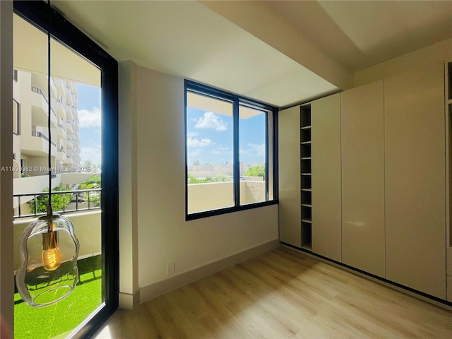 201 Crandon Blvd Unit 305, Key Biscayne, FL 33149 - unfurnished bedroom featuring light wood-style flooring and multiple windows