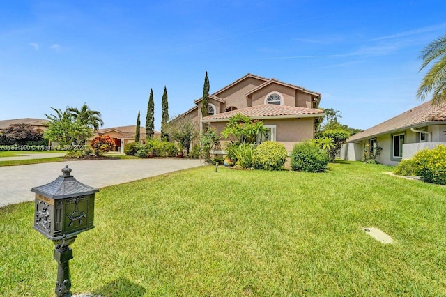 9940 SW 4th St, Plantation, FL 33324 - mediterranean / spanish-style house with stucco siding, a tiled roof, a front yard, and driveway
