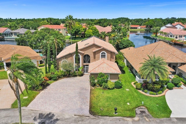 9940 SW 4th St, Plantation, FL 33324 - view of front of property with decorative driveway, a water view, a residential view, and stucco siding