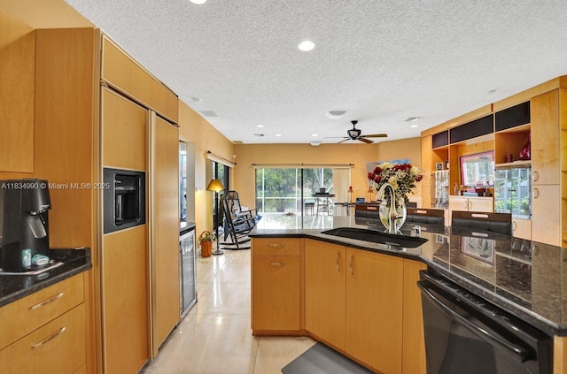 9940 SW 4th St, Plantation, FL 33324 - kitchen featuring black dishwasher, a textured ceiling, a peninsula, ceiling fan, and dark stone counters