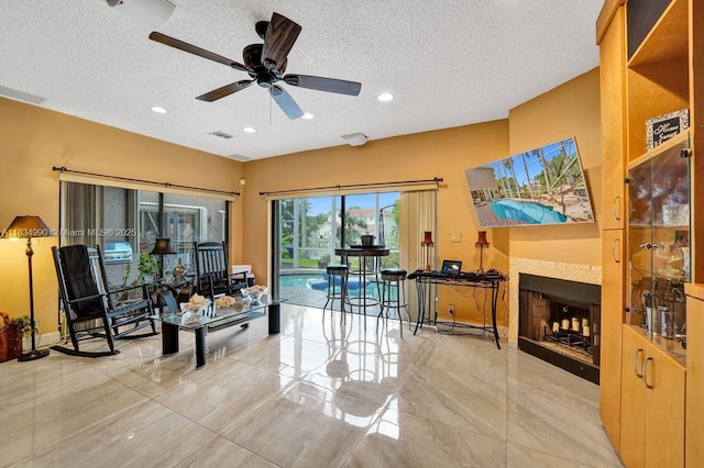9940 SW 4th St, Plantation, FL 33324 - living room with a textured ceiling, ceiling fan, a fireplace, and recessed lighting
