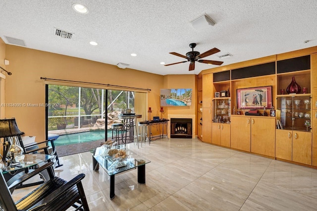 9940 SW 4th St, Plantation, FL 33324 - living room with a textured ceiling, ceiling fan, a fireplace, and recessed lighting