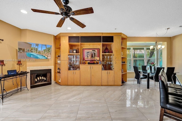 9940 SW 4th St, Plantation, FL 33324 - living area with a textured ceiling, a chandelier, a ceiling fan, recessed lighting, and a fireplace