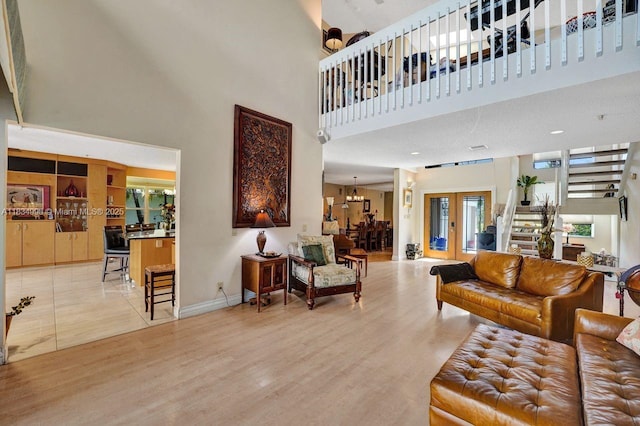 9940 SW 4th St, Plantation, FL 33324 - living area featuring a towering ceiling, french doors, and light wood-type flooring