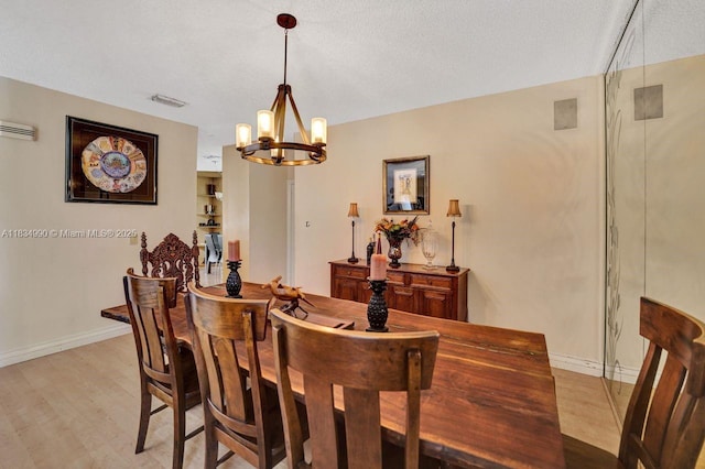 9940 SW 4th St, Plantation, FL 33324 - dining room featuring a chandelier, light wood-style floors, and a textured ceiling