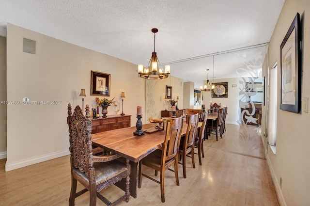 9940 SW 4th St, Plantation, FL 33324 - dining space featuring a chandelier, light wood-style floors, and a textured ceiling