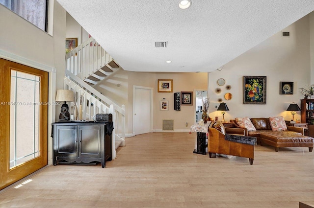 9940 SW 4th St, Plantation, FL 33324 - living room featuring stairs, a textured ceiling, wood finished floors, a high ceiling, and recessed lighting