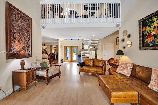 9940 SW 4th St, Plantation, FL 33324 - living area with light wood-style floors, stairway, and a towering ceiling