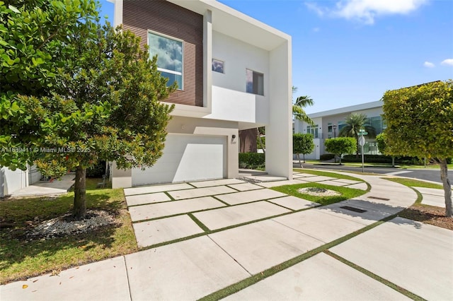 10431 NW 68th Ter, Doral, FL 33178 - contemporary house featuring stucco siding, an attached garage, and driveway