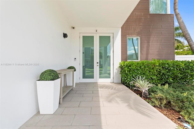 10431 NW 68th Ter, Doral, FL 33178 - view of exterior entry with french doors and stucco siding