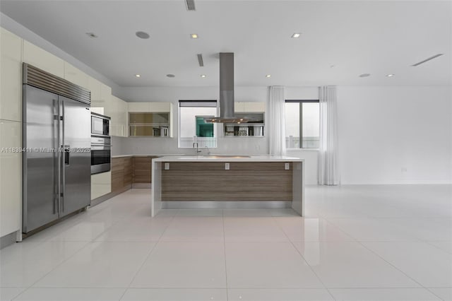 10431 NW 68th Ter, Doral, FL 33178 - kitchen with built in appliances, modern cabinets, island range hood, and light countertops