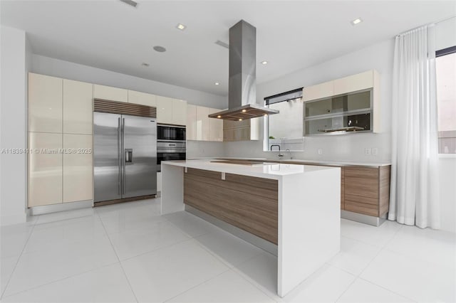 10431 NW 68th Ter, Doral, FL 33178 - kitchen with black appliances, island exhaust hood, modern cabinets, a kitchen island, and light countertops