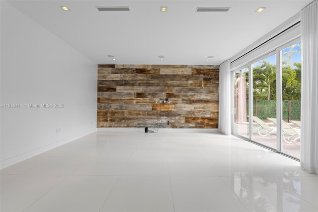 10431 NW 68th Ter, Doral, FL 33178 - unfurnished room featuring wooden walls, an accent wall, and recessed lighting