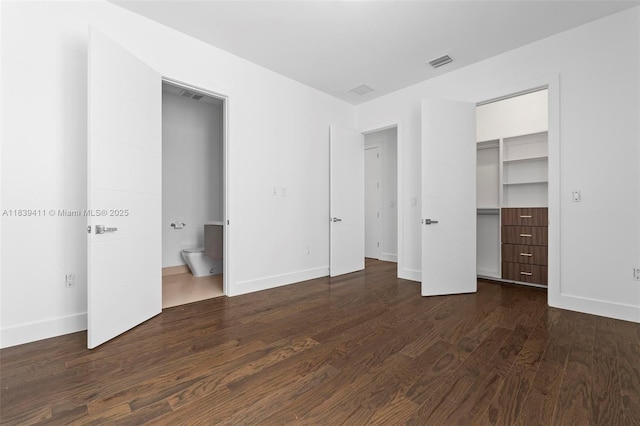 10431 NW 68th Ter, Doral, FL 33178 - unfurnished bedroom featuring dark wood-type flooring and a walk in closet