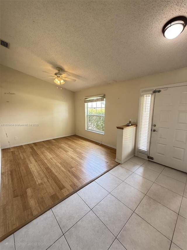 5338 NW S Crisona Cir, Port St Lucie, FL 34986 - foyer with a textured ceiling, light tile patterned floors, and a ceiling fan