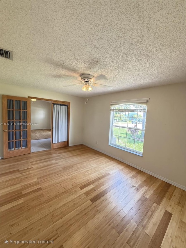 5338 NW S Crisona Cir, Port St Lucie, FL 34986 - spare room featuring wood finished floors, a ceiling fan, and a textured ceiling