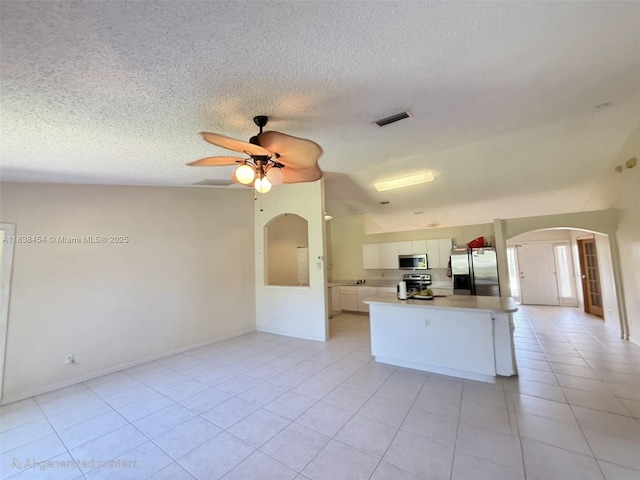 5338 NW S Crisona Cir, Port St Lucie, FL 34986 - kitchen with appliances with stainless steel finishes, arched walkways, white cabinetry, light countertops, and ceiling fan