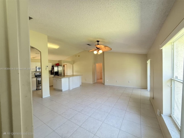 5338 NW S Crisona Cir, Port St Lucie, FL 34986 - unfurnished living room with a ceiling fan, light tile patterned floors, lofted ceiling, a textured ceiling, and arched walkways