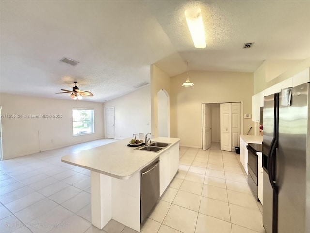 5338 NW S Crisona Cir, Port St Lucie, FL 34986 - kitchen with refrigerator with ice dispenser, stainless steel dishwasher, light countertops, light tile patterned floors, and a textured ceiling