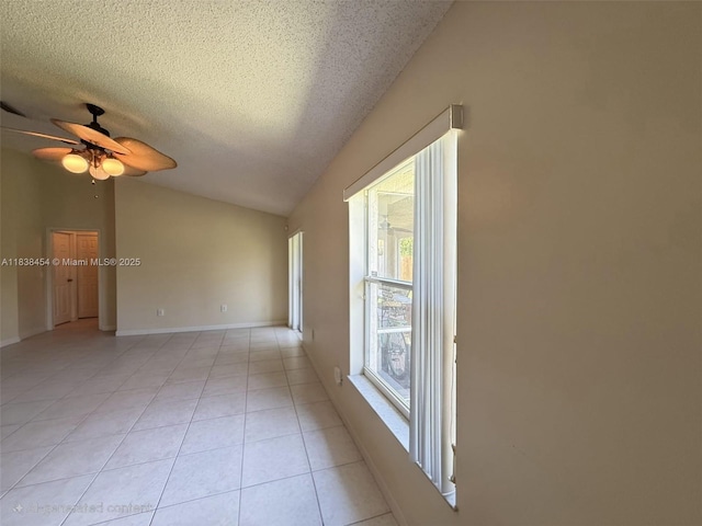 5338 NW S Crisona Cir, Port St Lucie, FL 34986 - empty room with vaulted ceiling, light tile patterned flooring, ceiling fan, and a textured ceiling