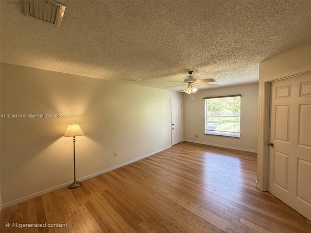 5338 NW S Crisona Cir, Port St Lucie, FL 34986 - unfurnished room featuring a textured ceiling, ceiling fan, and light wood finished floors