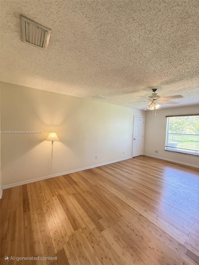 5338 NW S Crisona Cir, Port St Lucie, FL 34986 - spare room with a textured ceiling, a ceiling fan, and light wood-type flooring