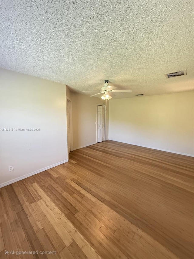5338 NW S Crisona Cir, Port St Lucie, FL 34986 - unfurnished room featuring a textured ceiling, hardwood / wood-style flooring, and a ceiling fan