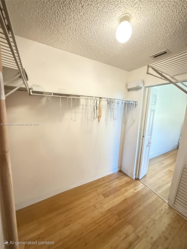 5338 NW S Crisona Cir, Port St Lucie, FL 34986 - walk in closet with light wood-type flooring and a wall mounted AC