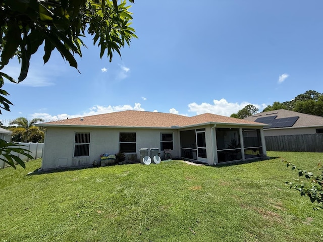 5338 NW S Crisona Cir, Port St Lucie, FL 34986 - back of property with a sunroom, a fenced backyard, and stucco siding