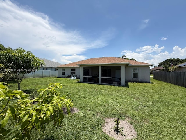 5338 NW S Crisona Cir, Port St Lucie, FL 34986 - back of property with a sunroom, a fenced backyard, and stucco siding