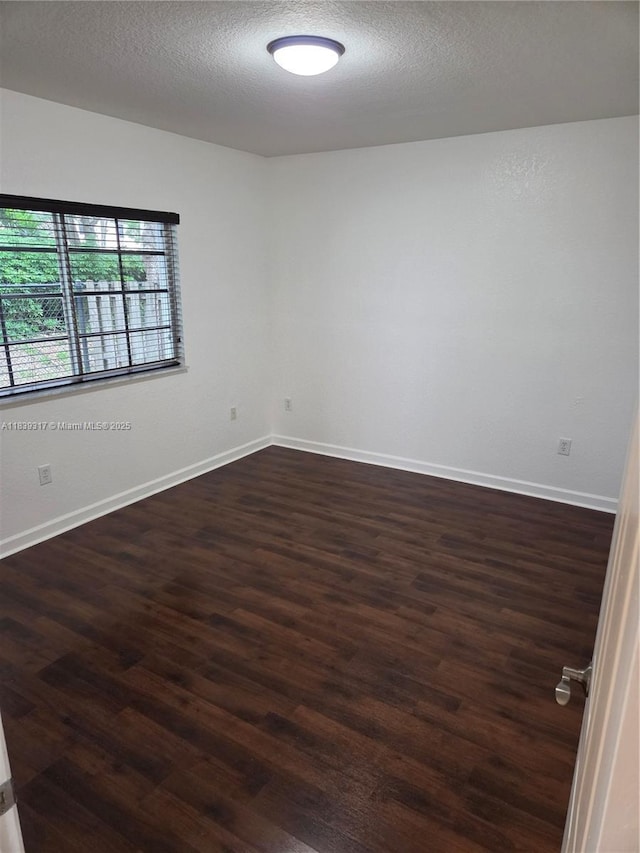2630 NE 3rd Dr Unit 101, Homestead, FL 33033 - unfurnished room featuring dark wood-type flooring and a textured ceiling