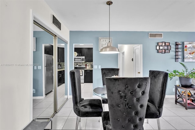 5800 NE 22nd Way Unit 523, Fort Lauderdale, FL 33308 - dining area featuring light tile patterned floors and baseboards