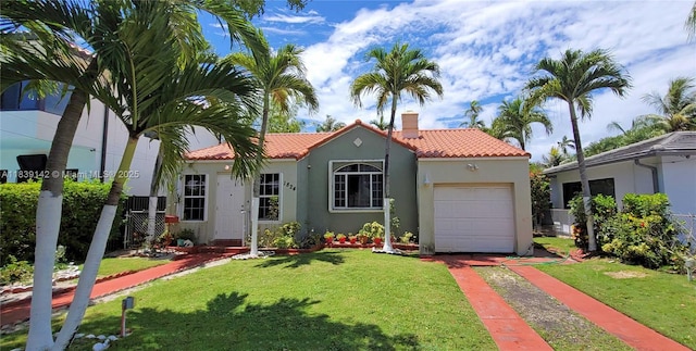 1824 SW 24th St, Miami, FL 33145 - mediterranean / spanish-style house featuring a tile roof, stucco siding, a chimney, driveway, and an attached garage