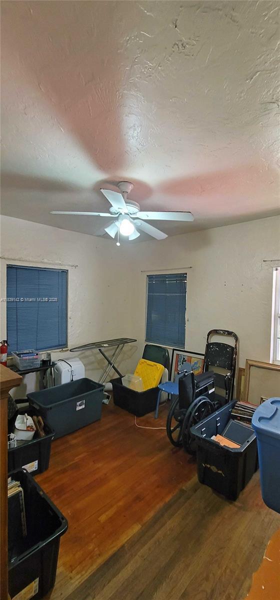 1824 SW 24th St, Miami, FL 33145 - living room featuring wood finished floors, a textured ceiling, and a ceiling fan
