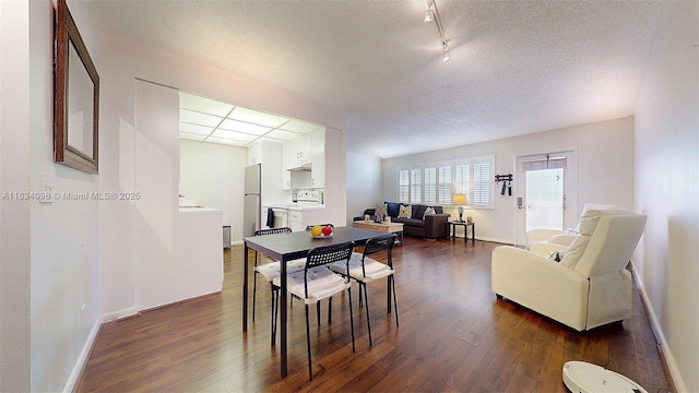 4047 Rexford C Unit 4047, Boca Raton, FL 33434 - dining space featuring dark wood-type flooring, a textured ceiling, and rail lighting