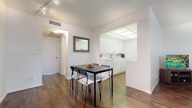 4047 Rexford C Unit 4047, Boca Raton, FL 33434 - dining area with wood finished floors, a textured ceiling, and track lighting