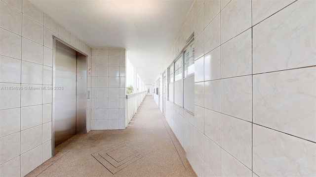 4047 Rexford C Unit 4047, Boca Raton, FL 33434 - hallway with elevator and tile walls
