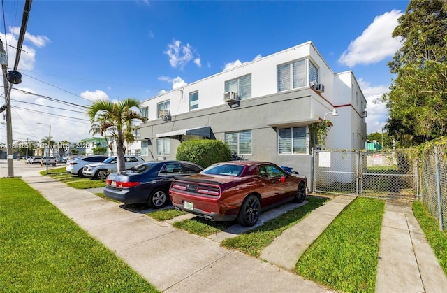 539 NE 82nd Ter, Miami, FL 33138 - view of front of home featuring stucco siding, cooling unit, and uncovered parking