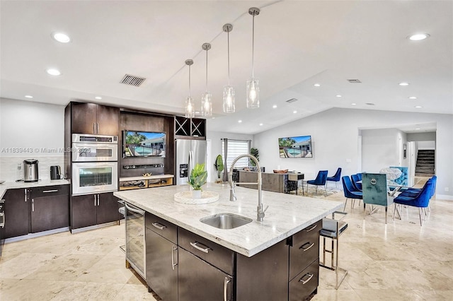 614 SE 12th Ave, Deerfield Beach, FL 33441 - kitchen with appliances with stainless steel finishes, a breakfast bar, dark brown cabinets, pendant lighting, and recessed lighting