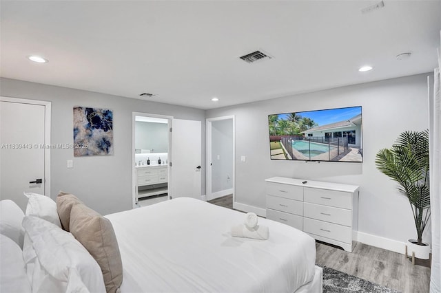 614 SE 12th Ave, Deerfield Beach, FL 33441 - bedroom with light wood-style flooring, recessed lighting, and connected bathroom