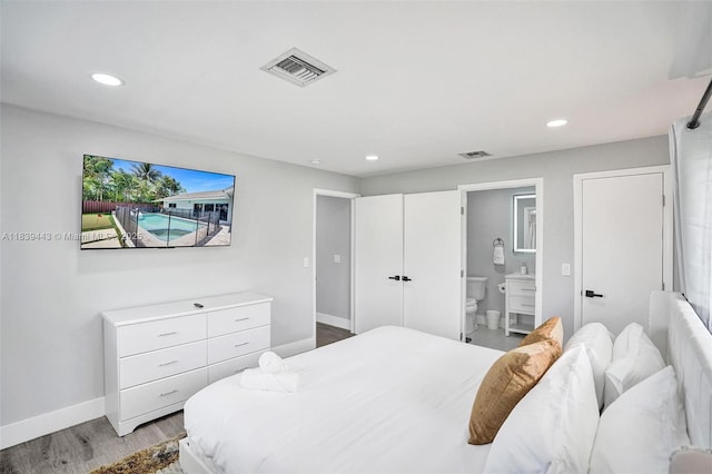 614 SE 12th Ave, Deerfield Beach, FL 33441 - bedroom featuring recessed lighting, light wood-style flooring, and connected bathroom